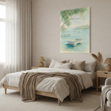 A coastal landscape canvas print featuring a small boat on a serene blue water bay with green trees, styled on a neutral beige bedroom wall above a bed with neutral-toned bedding.