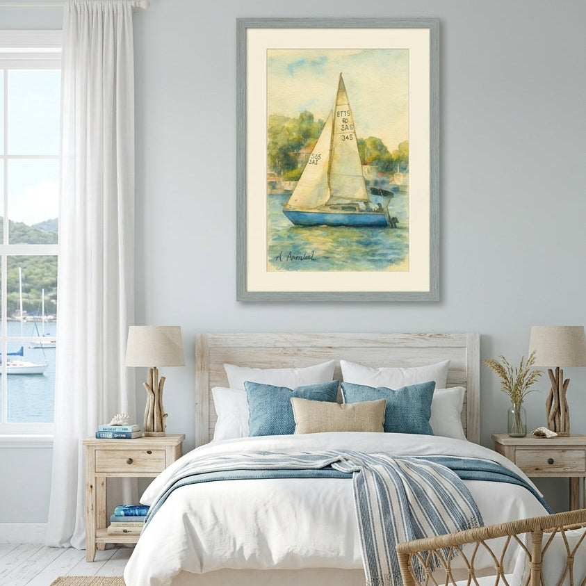 A framed art print of a sailboat on water, displayed on a light gray wall above a neatly made bed in a bright, modern bedroom.