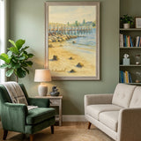 A framed beach scene painting hangs on a sage green wall in a styled therapy office or living room, with a green armchair, cream sofa, lamp, plant, and bookshelves visible.